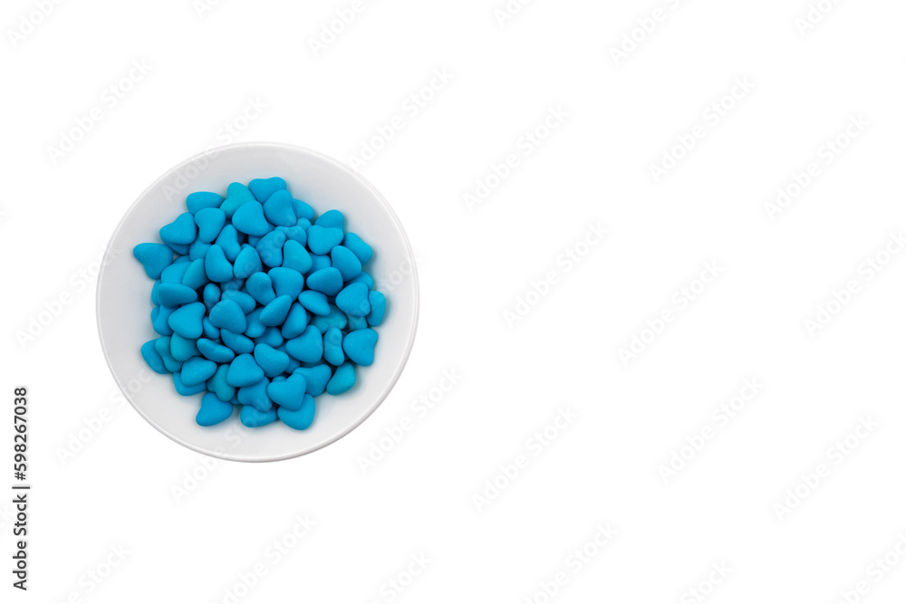 White plate with blue heart-shaped candies (close-up) isolated on white background White plate with blue heart-shaped candies (close-up) isolated on white background