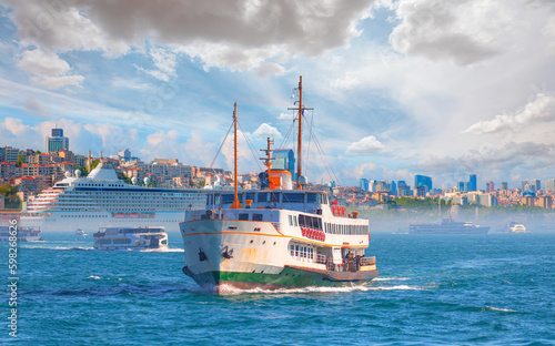Cruise ship and ferry (steamboat) traffic in the Bosphorus - Sea voyage with old ferry (steamboat) on the Bosporus - Coastal cityscape with modern buildings under cloudy sky - Istanbul, Turkey 