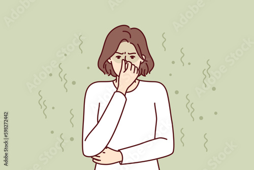 Woman closes nose in disgust at smell and toxic aroma caused by violation of hygiene rules. Young girl in white sweater feels stink and bad smell of clothes or socks in need of washing Generative AI