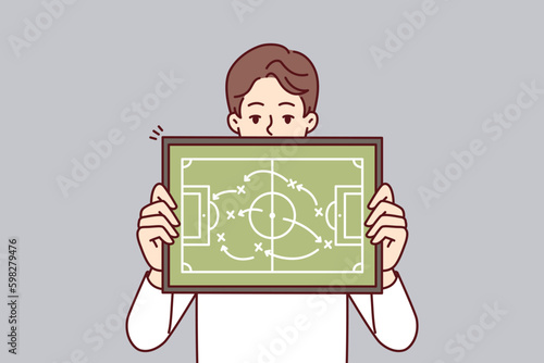 Man referee demonstrates plan for placement of football players teaching athletes tactics of conducting game in soccer. Guy football manager gives recommendation on tactics and strategy Generative AI