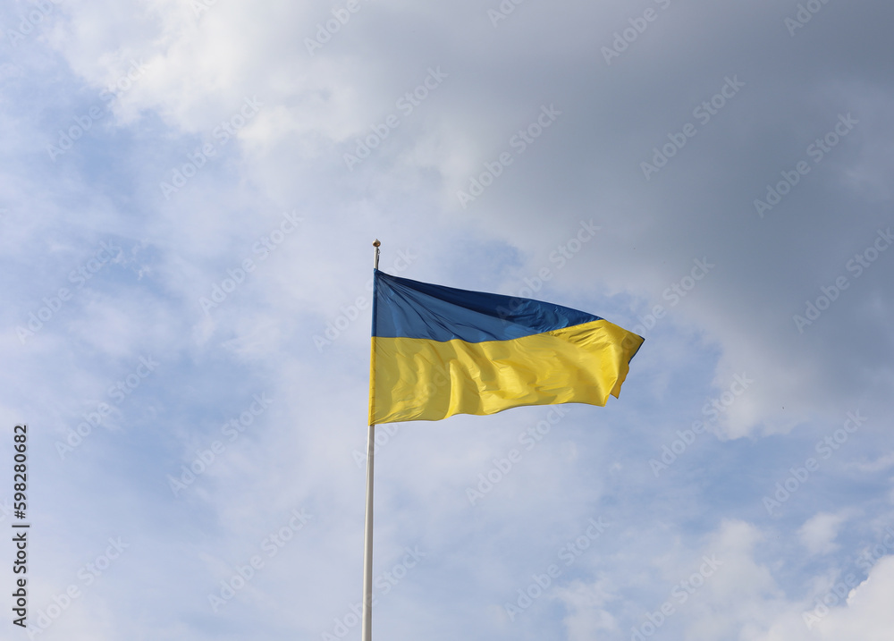 Ukrainian flag on blue sky. Country flag against sky. Flags of the world. Peace in the world. Peaceful flag. Ukrainian flag on blue sky. Country flag against sky. Flags of the world. Peace in the world. Peaceful flag.