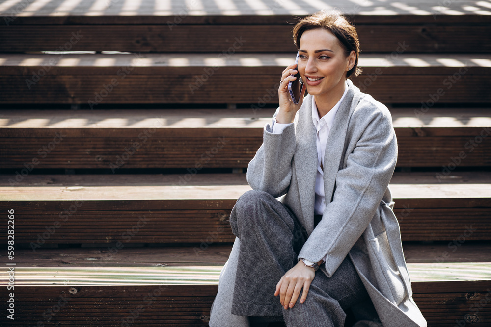Business woman sitting on stairs and working on tablet Business woman sitting on stairs and working on tablet