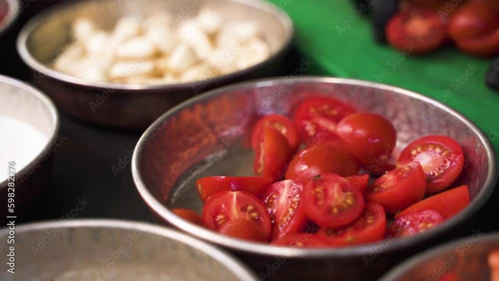 red chili peppers.Pour the chopped tomatoes into the bowl and chop some tomatoes on the board red chili peppers.Pour the chopped tomatoes into the bowl and chop some tomatoes on the board