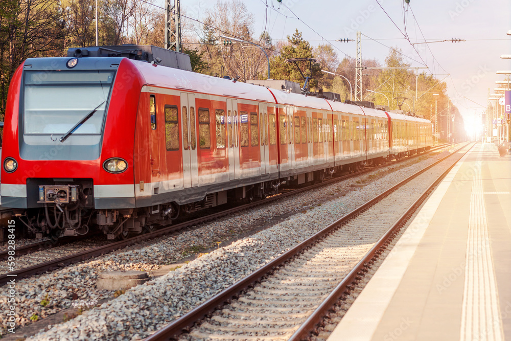 Electric Passenger Train on Railway Station. Modern Speed Train on Railroad Platform with Sun light. Electric Passenger Train on Railway Station. Modern Speed Train on Railroad Platform with Sun light.