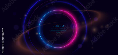 Abstract technology futuristic neon circle glowing blue and pink light lines with speed motion blur effect on dark blue background.