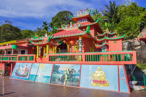 The front of the red temple or shrine with Chinese buildings theme with reliefs of gods and goddesses, a place of worship for Buddhists in Tarempa, Anambas Islands, Riau Archipelago, Indonesia. photo