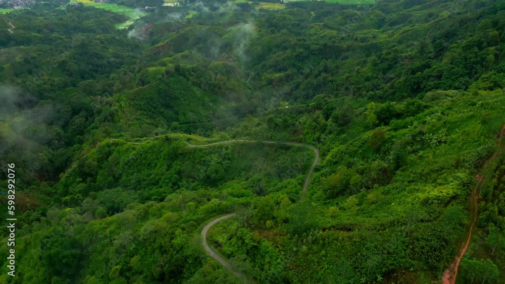Aerial view of winding road in the middle of a field Aerial view of winding road in the middle of a field