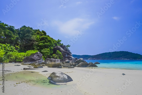 Penjalin Island  Anambas  Tropical beach with rocks  coconut trees  and blue sky with clouds on Sunny day. Summer tropical landscape  panoramic view. travel tourism panorama background concept.