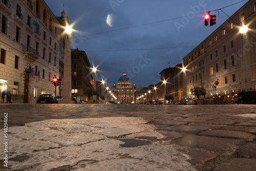 Rome, Via della Conciliazione at night with accent on cobblestones and view of St Peter's Basilica in the background, long exposure photo