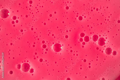 Bubble pink background texture. Berry gel to cleanse the skin of the face and body. Spa treatments, skin care. Bath foam, detergent. Slime pink.