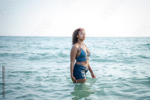 African girl having fun on a sunny day on the beach at summer vacation.
