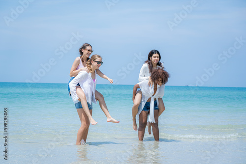 Young woman playing together on tropical beach at summer,Summer vacation concept.