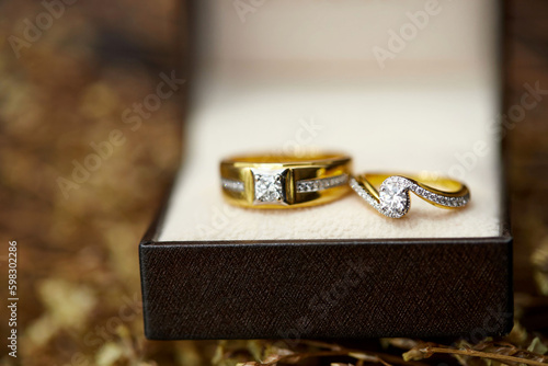 Close-up view of gold diamond wedding rings © Anucha