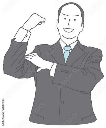 握り拳のポーズをするスーツを着た男性