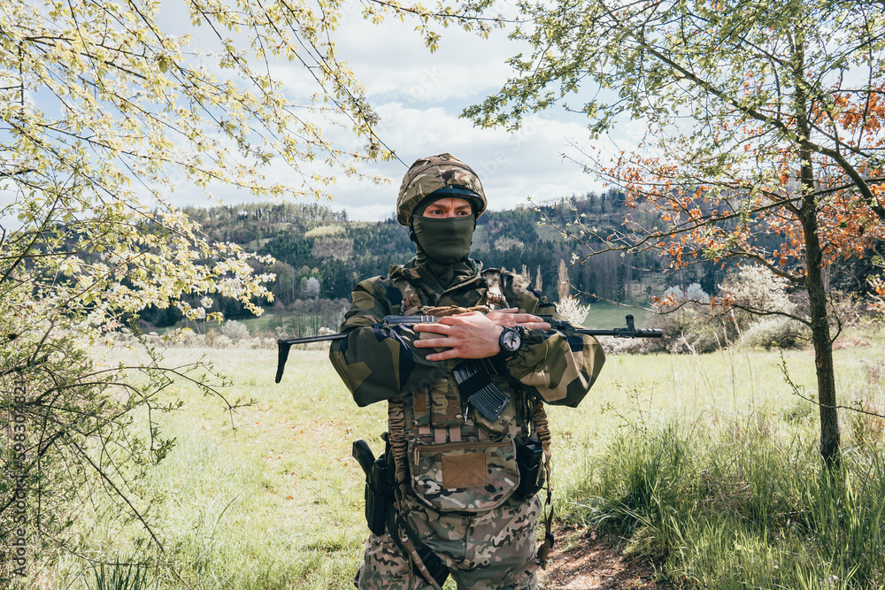 Fototapeta premium Soldier in a trench. Member of the International Legion patrols. The war in Ukraine.Army soldier Patrolled the front line, Soldier with assault rifle. 