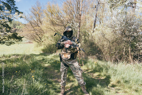 Asoldier of an international unit fighting in the war in Ukraine. Full combat gear. submachine gun, camouflage uniform balitic vest