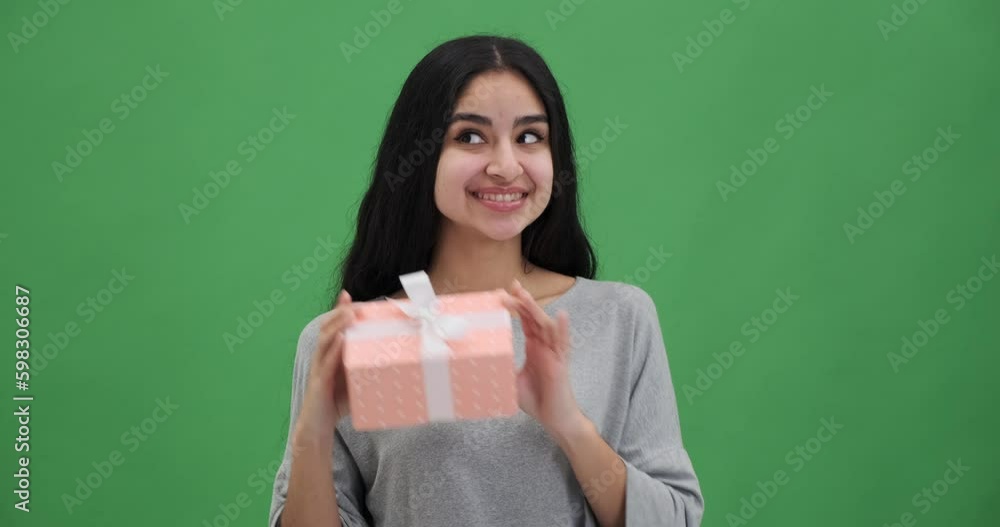 Excited woman shaking and guessing the present in gift box Generative AI Excited woman shaking and guessing the present in gift box Generative AI