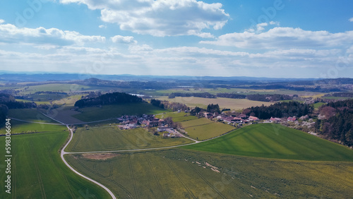 Green field  farmland with picturesque European landscape. Road in the middle of fields. Soft light. footage video drone view. in the background a range of mountains