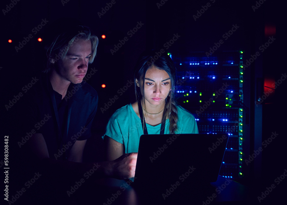 Technicians using laptop in server room Technicians using laptop in server room