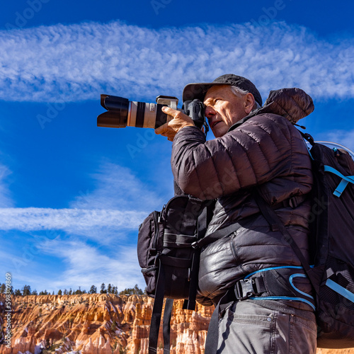 United States, Utah, Senior photographer photographing in Zion National Park photo