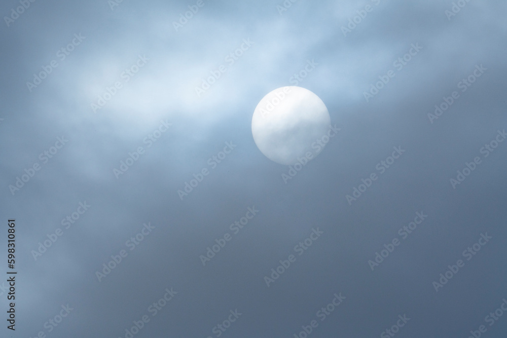 Hazy sun behind wispy clouds Hazy sun behind wispy clouds