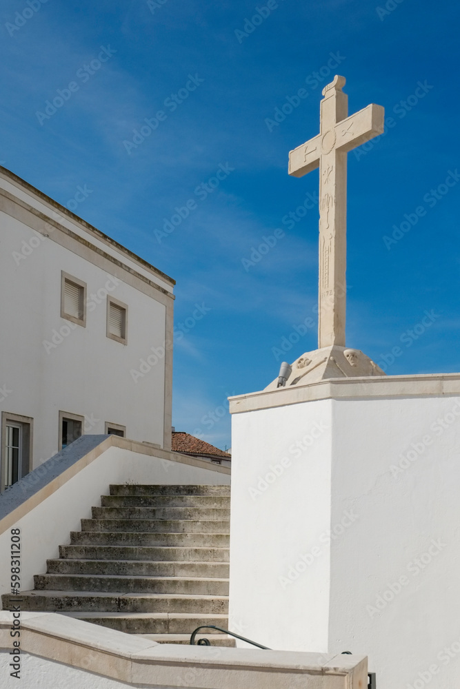Portugal, Torres Novas, Cross on white church against blue sky Portugal, Torres Novas, Cross on white church against blue sky