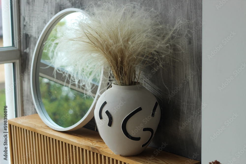 Fototapeta premium A modern vase with a mirror in a cozy interior.
