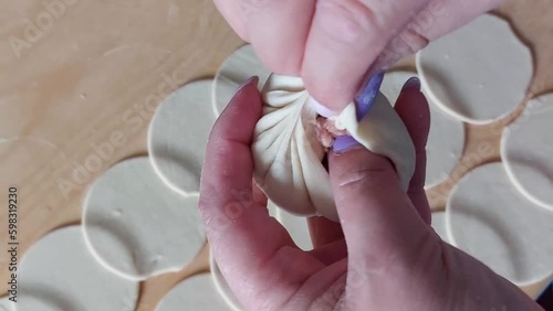 Traditional Buryad Buuz making process. Steamed dumpling filled with meat	
 photo