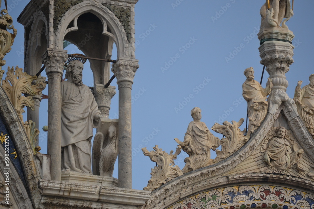 an adornment of a building with copious human possibly sacred sculptures in Venice Italy