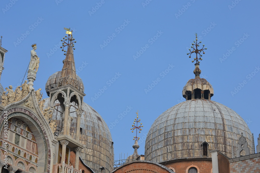 Dome of a church in Venice with rich decoration and crosses on the domes