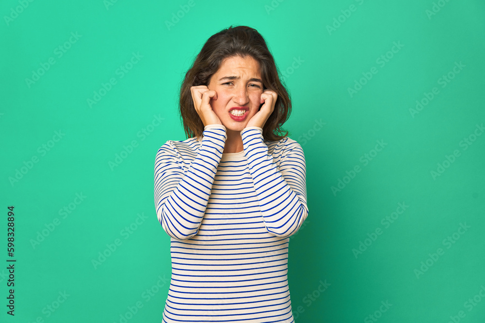 Young caucasian woman isolated covering ears with hands. Young caucasian woman isolated covering ears with hands.
