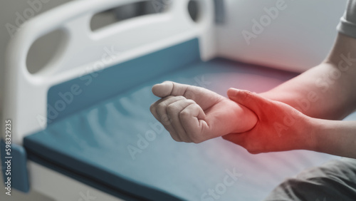 Close up man suffering from wrist pain.