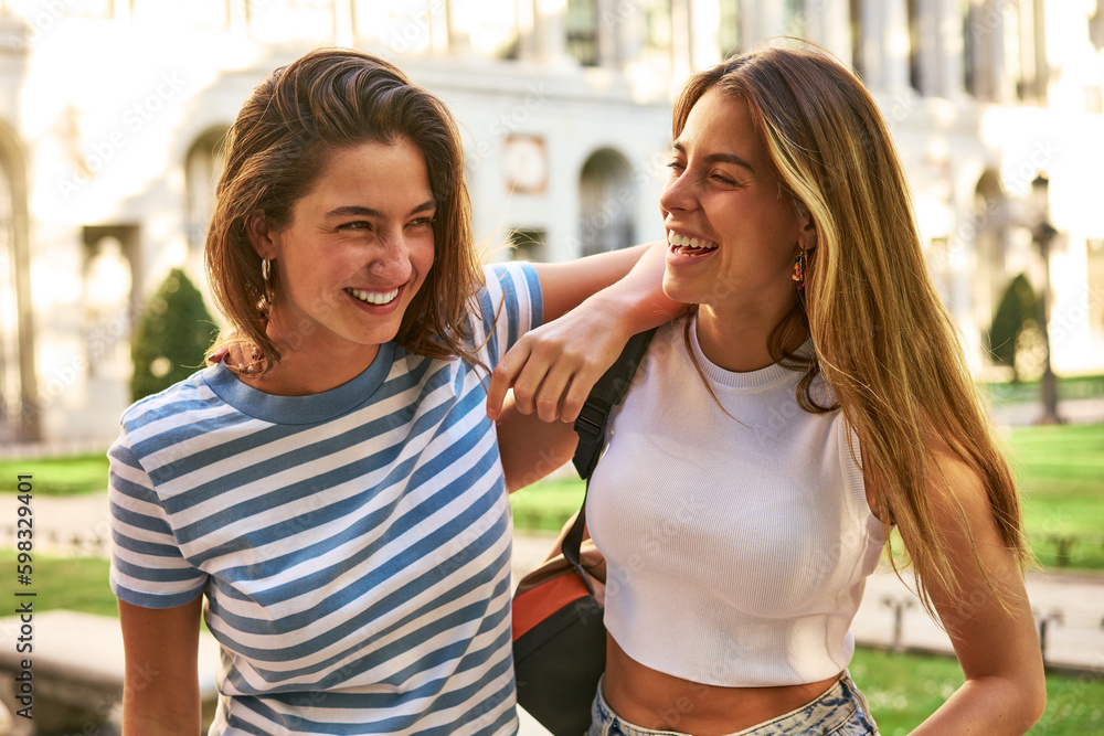 Two friends enjoy laughter and fun in a park. Two friends enjoy laughter and fun in a park.
