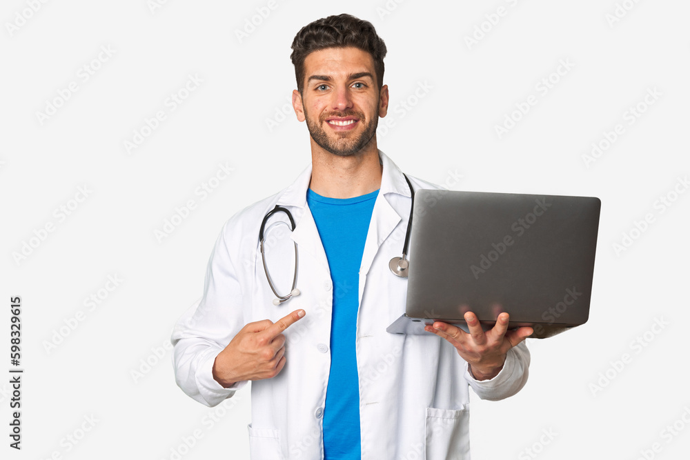 Young doctor man holding a laptop smiling and pointing aside, showing something at blank space. Young doctor man holding a laptop smiling and pointing aside, showing something at blank space.