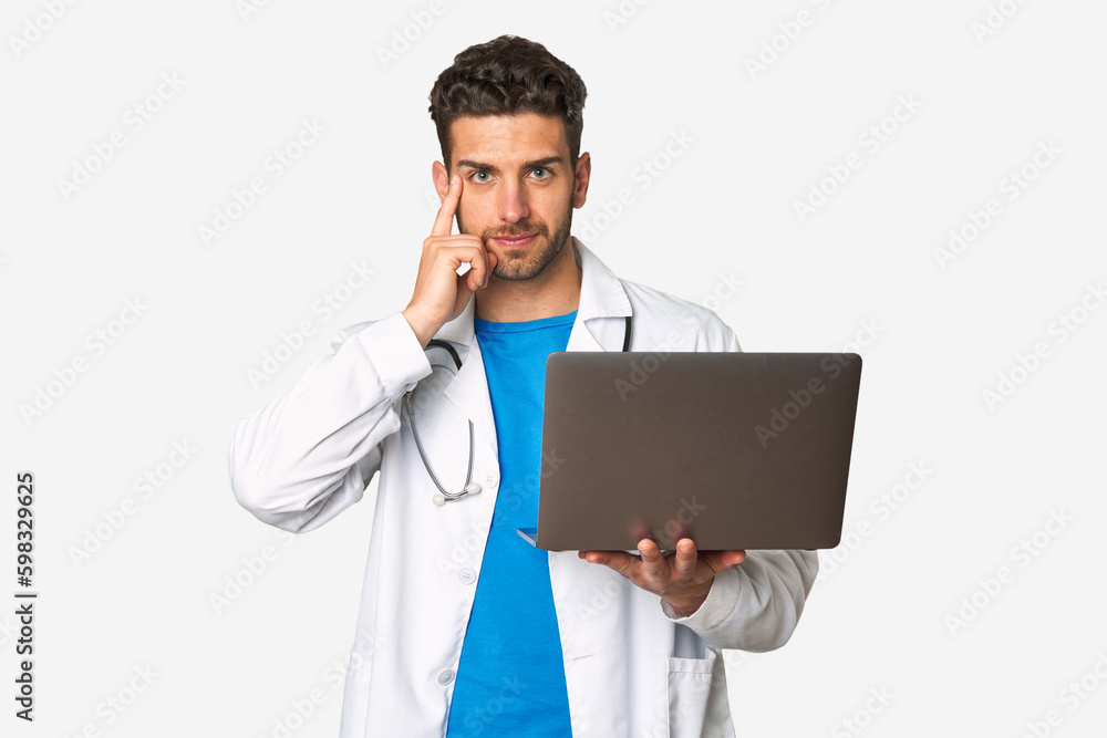 Young doctor man holding a laptop pointing temple with finger, thinking, focused on a task. Young doctor man holding a laptop pointing temple with finger, thinking, focused on a task.