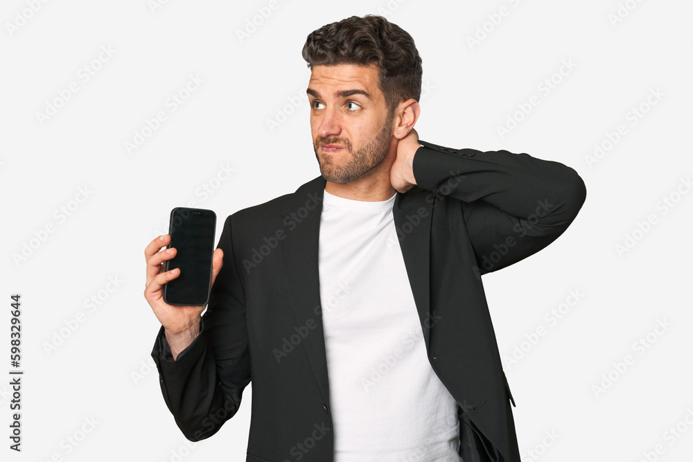 Young business caucasian man touching back of head, thinking and making a choice. Young business caucasian man touching back of head, thinking and making a choice.