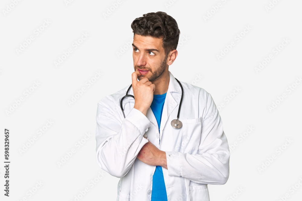 Young doctor man relaxed thinking about something looking at a copy space. Young doctor man relaxed thinking about something looking at a copy space.