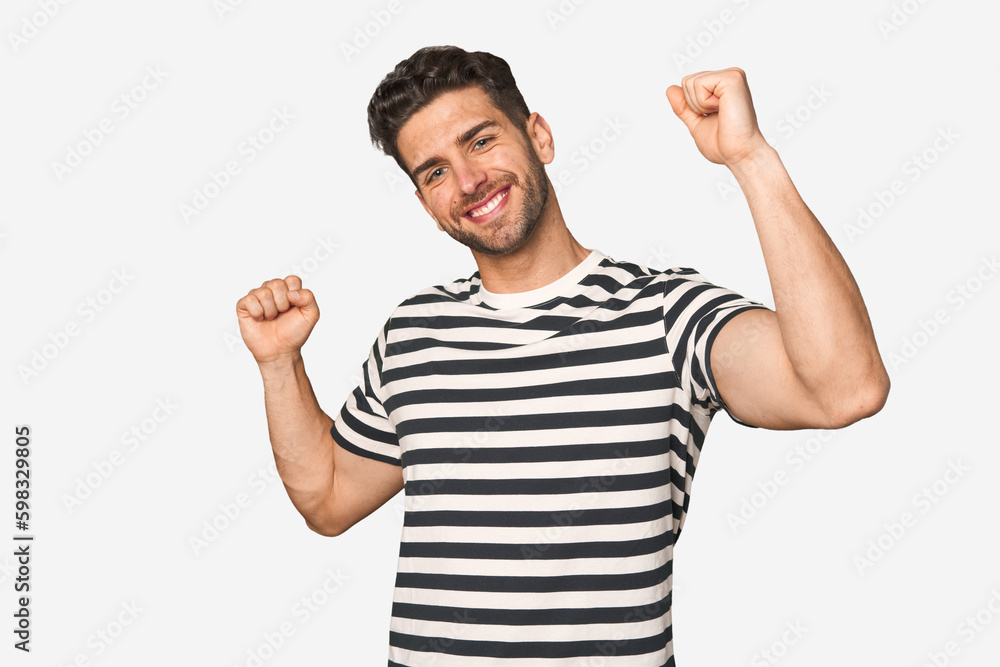Young handsome man isolated celebrating a special day, jumps and raise arms with energy. Young handsome man isolated celebrating a special day, jumps and raise arms with energy.