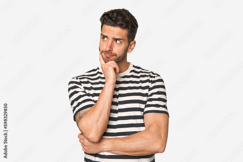 Young handsome man isolated thinking and looking up, being reflective, contemplating, having a fantasy. Young handsome man isolated thinking and looking up, being reflective, contemplating, having a fantasy.