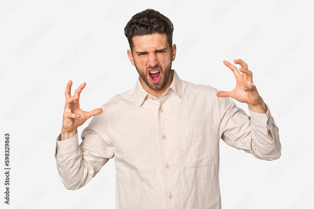 Young handsome man isolated screaming with rage. Young handsome man isolated screaming with rage.