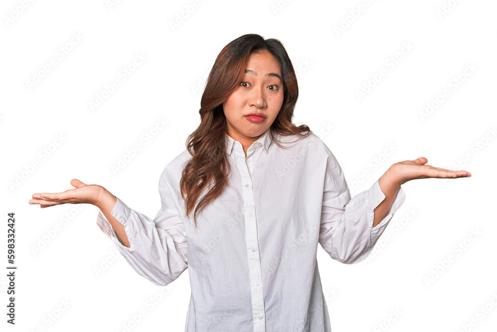 A young chinese woman doubting and shrugging shoulders in questioning gesture. A young chinese woman doubting and shrugging shoulders in questioning gesture.