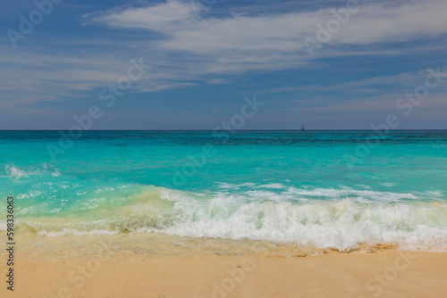 Beautiful view of sandy beach of Eagle Beach with turquoise water of Atlantic Ocean on island of Aruba.