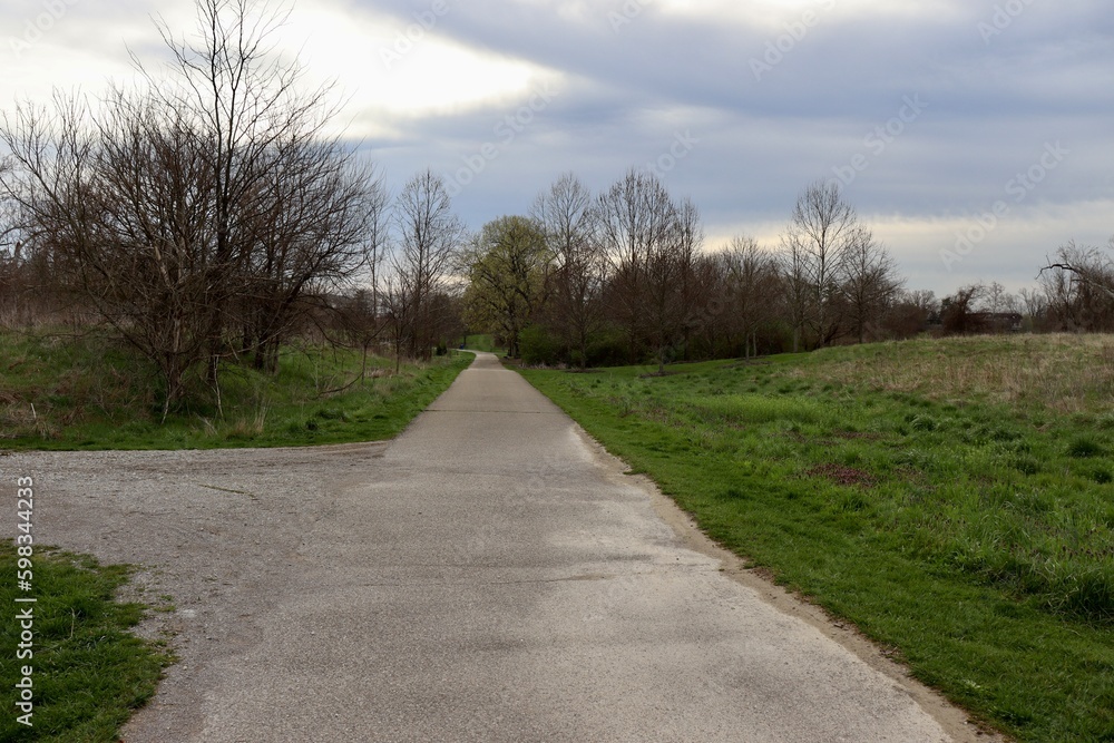 The empty pathway on a cloudy spring day.