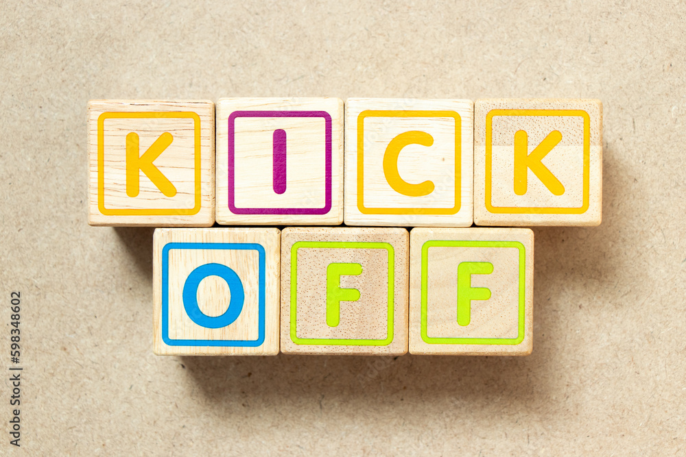 Wooden alphabet letter block in word kick off on wood background