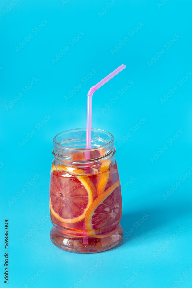 red orange lemonade in a glass jar on a blue background red orange lemonade in a glass jar on a blue background