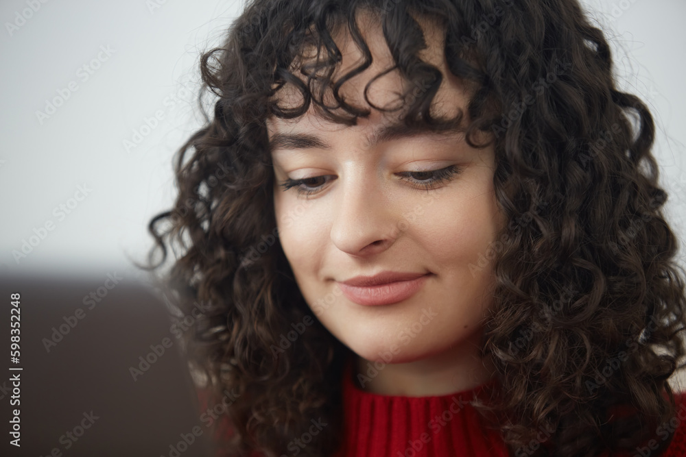 Portrait of a beautiful brunette girl working on a computer. Attractive Ukrainian female person with curly hair using a laptop for education or work Portrait of a beautiful brunette girl working on a computer. Attractive Ukrainian female person with curly hair using a laptop for education or work