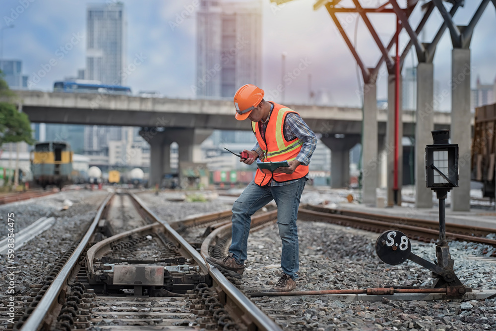 Engineer sitting on railway inspection. construction worker on railways. Engineer work on Railway. Rail, engineer, Infrastructure Engineer sitting on railway inspection. construction worker on railways. Engineer work on Railway. Rail, engineer, Infrastructure