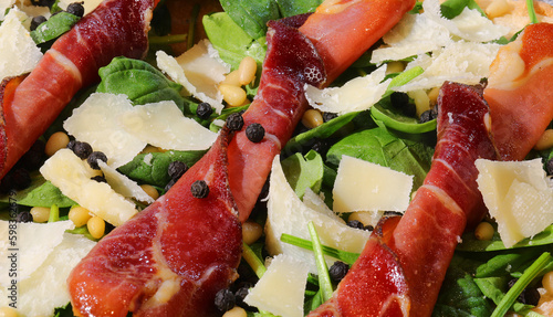 cold dish made with sliced bresaola flakes of grana cheese and green rocket leaves