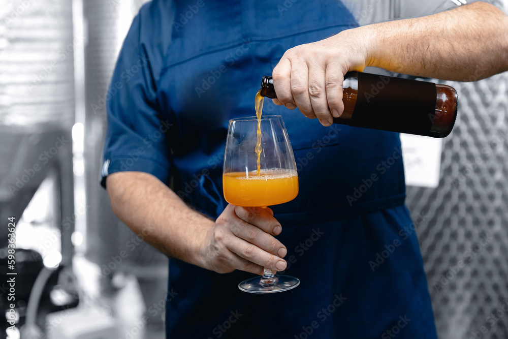 Quality control beer mead, worker tests and evaluates taste of drink at brewery Quality control beer mead, worker tests and evaluates taste of drink at brewery