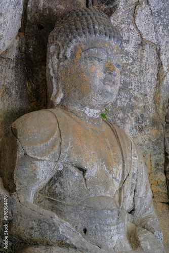 Usuki, Japan - May 1, 2023: Detail of one of the Usuki Stone Buddhas. They are a set of sculptures carved in rock during the 12th century in Usuki, Japan.